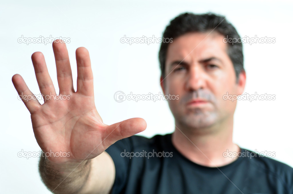 Upset mature man show stop sign with his palm. 