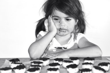 Little girl getting caught eating chocolate cookies clipart