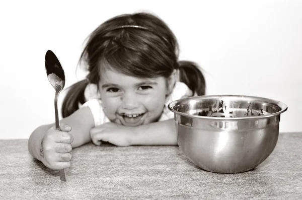 Little girl getting caught finishing all the chocolate cream — Stock Photo, Image