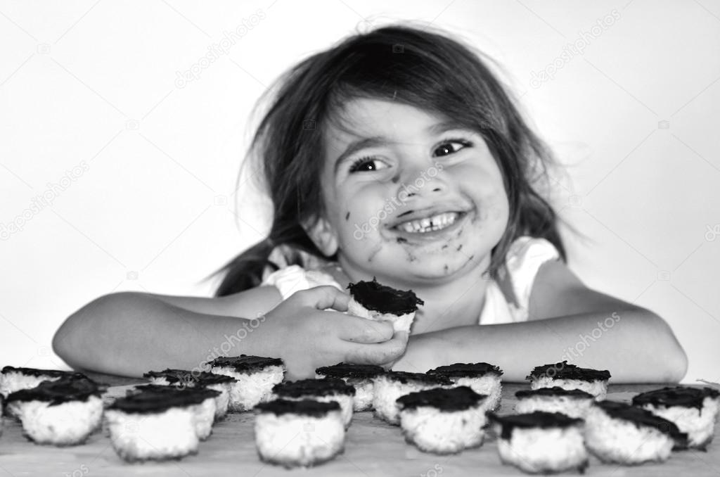 Little girl getting caught eating chocolate cookies