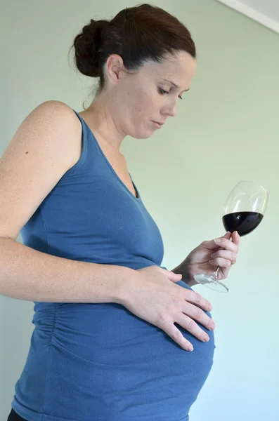 Pregnant woman drink red wine — Stock Photo, Image