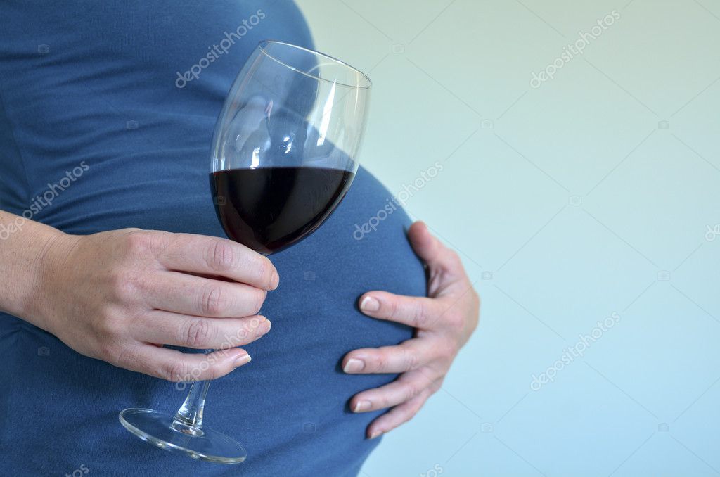 Pregnant woman drink red wine Stock Photo by ©lucidwaters 48068181