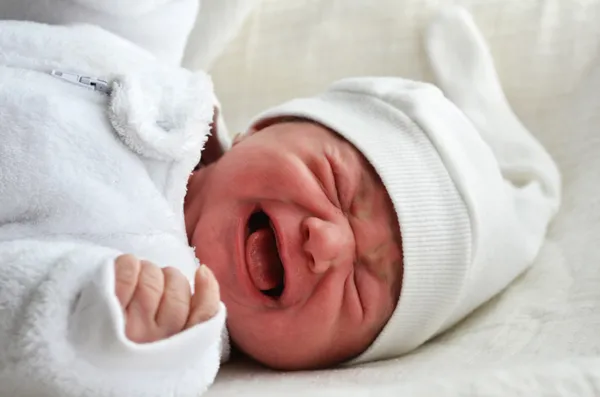 Newborn baby in a cot — Stock Photo, Image