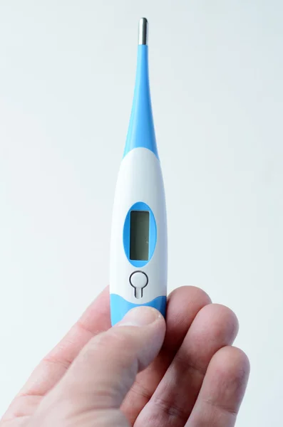 Man hand holds Thermometer — Stock Photo, Image