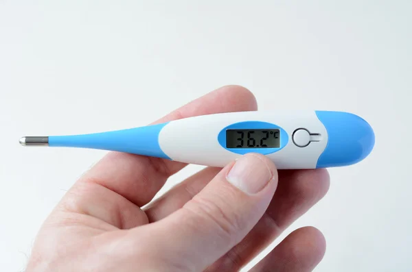 Man hand holds Thermometer — Stock Photo, Image