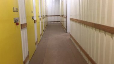 Corridor full of doors in unrecognizable self storage place.No people. Copy space