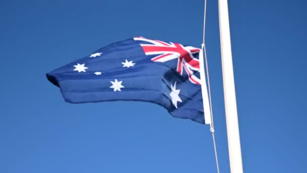 Australia National Flag Waving Clear Blue Sky — стоковое видео