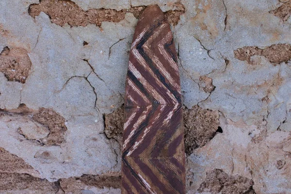 Aboriginal Australians people ancient  wooden shield weapon leaning on an old house wall.