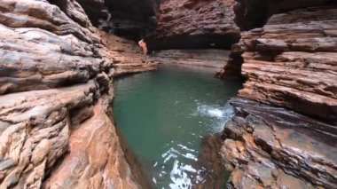 Kermits Pool swimming hole located in a canyon at the end of the Spider Walk at Hancock Gorge in Karijini National Park, Pilbara region Western Australia.