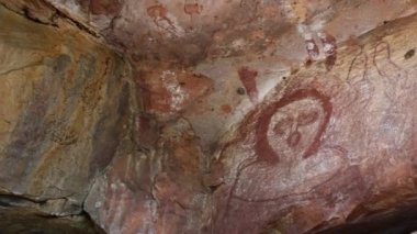 DERBY, WA - JULY 15 2022:Wandjina dreamtime images a cloud and rain spirits from Australian Aboriginal mythology painted on rock galleries in a cave in Kimberley Western Australia. 