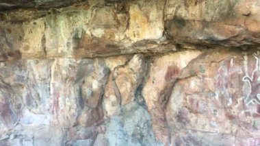 Wandjina dreamtime images a cloud and rain spirits from Australian Aboriginal mythology painted on rock gallery in Kimberley Western Australia.