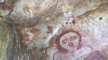 Wandjina dreamtime images a cloud and rain spirits from Australian Aboriginal mythology painted on rock gallery in Kimberley Western Australia.