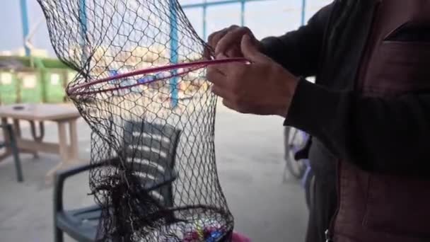 Fisherman Repairs Folding Fish Trap Net Marine — Stock Video