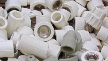 Many White Pvc Water Supply Pipe Fittings Close Up Footage.