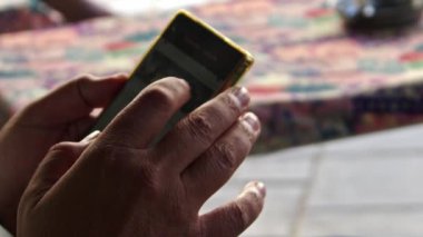 Hand Shooting of a Male Human Hand Cellphone Playing a Mobile Phone Game Footage.