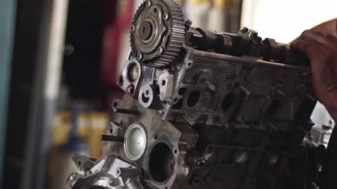 Car Master Assembles Refurbished Car Engine Parts In Repair Workshop Footage.