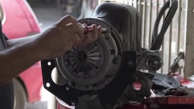 Car Master Assembles Clutch Release Parts Of Refurbished Car Engine With A Socket Screwdriver Footage.