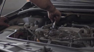 Installation of Car Engine Fuel Injector in the Repair Shop.