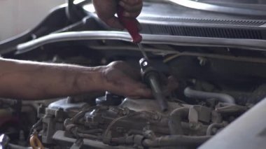 Car Fuel Injector Removal in the Repair Shop.