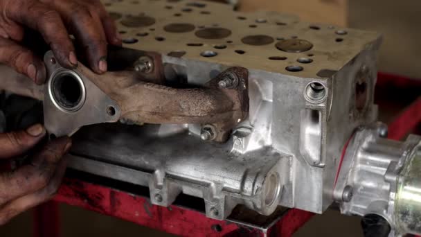 Mechanic Installs Exhaust Manifold Reconditioned Car Engine Footage — стоковое видео