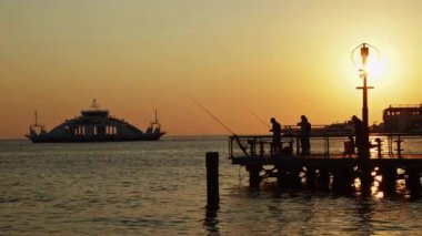 Fishermen Fishing Fishing Rod at the Pier at Sunset Footage.