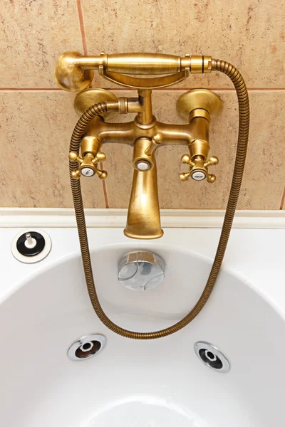 Vintage bathtub faucet and ceramic tiles in background — Stock Photo, Image