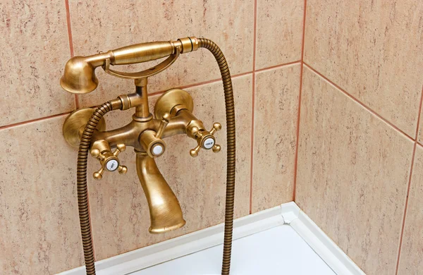 Vintage bathtub faucet and ceramic tiles in background — Stock Photo, Image