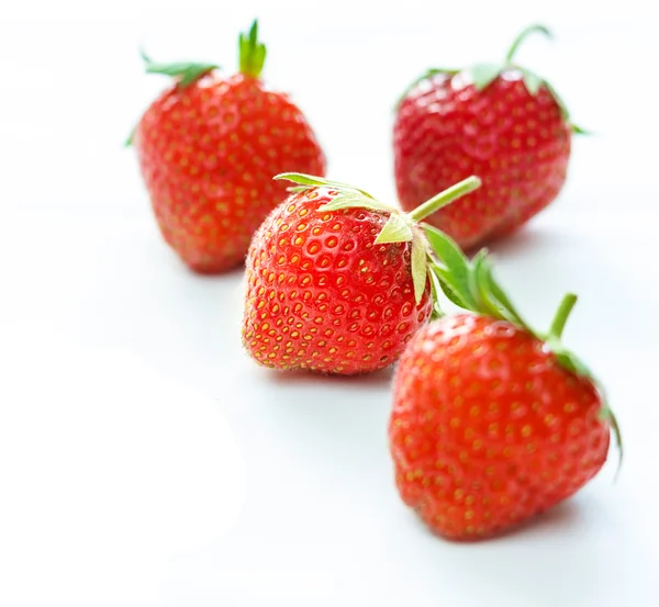 Close-up of four fresh vibrant strawberries — Stock Photo, Image