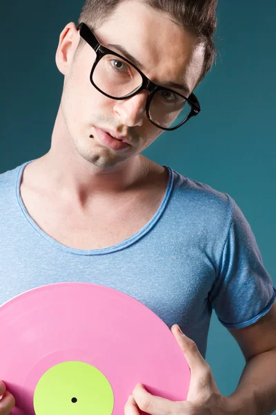 Deejay with transparent glasses holding pink viny — Stock Photo, Image