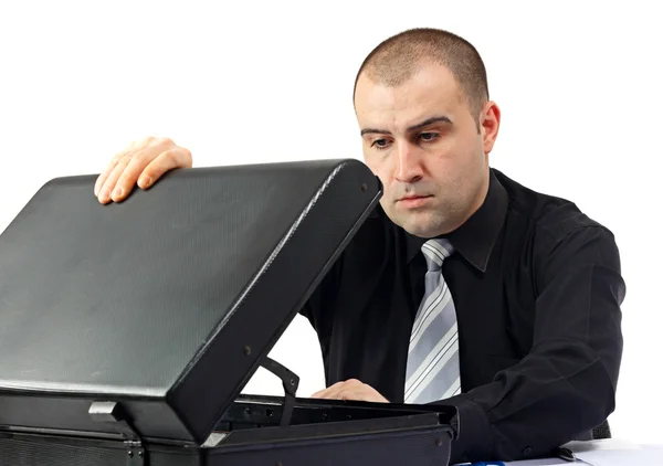 Business man having a confused look at his empty suitcase Stock Image