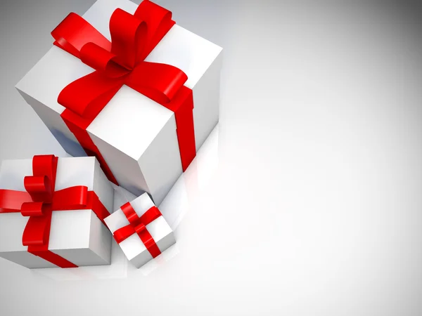 Three white gift boxes with red ribbon on white floor — Stock Photo, Image