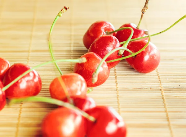Group of cherries placed on bamboo tablecloth — Stock Photo, Image