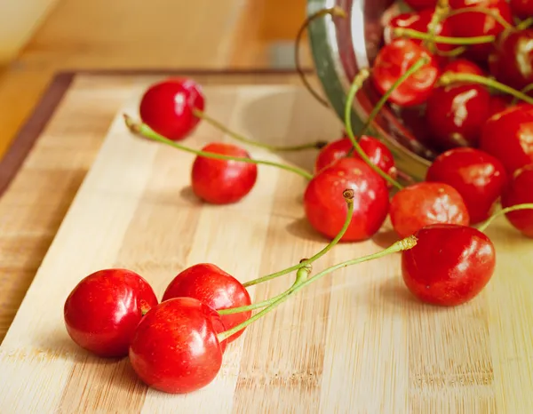 Group of cherries rolled out of bowl — Stock Photo, Image