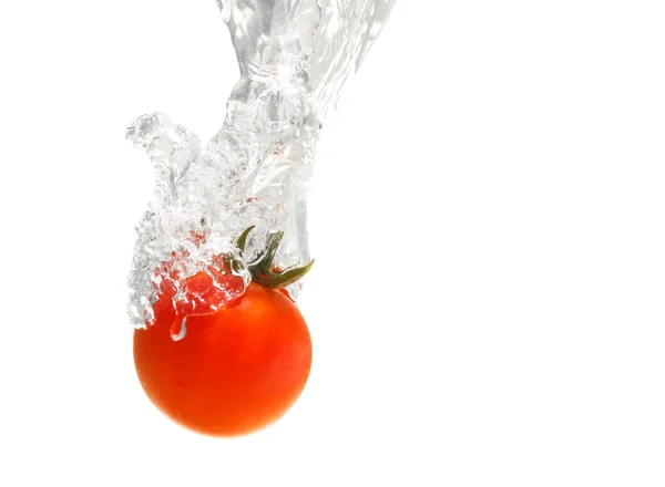 Juicy small cherry tomato dropped in water — Stock Photo, Image
