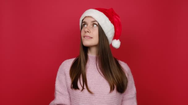 Confused Young Santa Brunette Woman 20S Knitted Sweater Christmas Hat — Stock Video