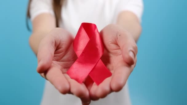 Close Female Hands Holding Small Red Aids Awareness Ribbon Posing — Stock Video