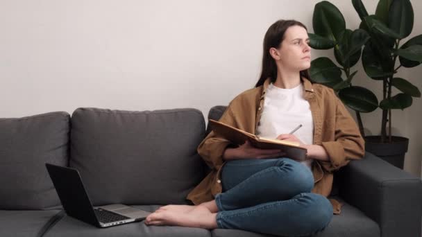 Young Female Entrepreneur Writing Notes Sit Sofa Focused Woman Work — Stock Video