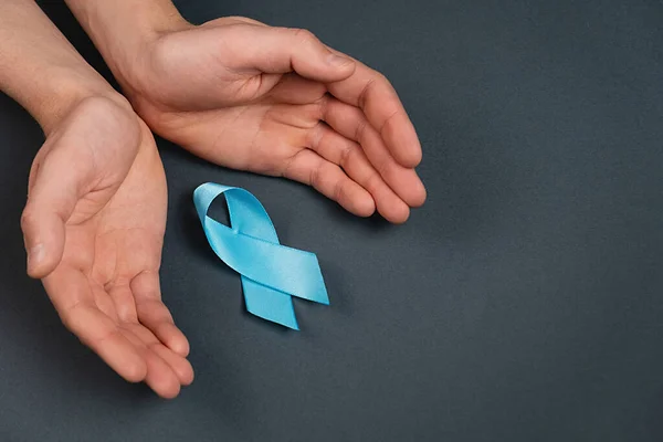 Close Male Hands Blue Ribbon Grey Studio Background Wall Prostate — Fotografia de Stock