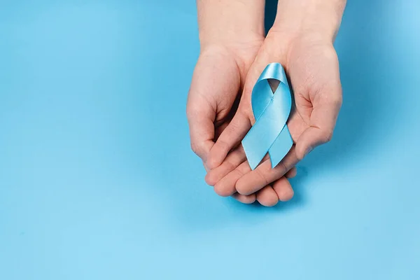 Top View Close Male Hands Holding Small Blue Awareness Ribbon — 스톡 사진