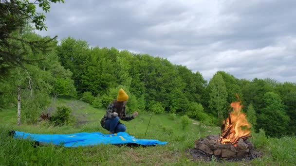 Young Female Traveler Knit Yellow Beanie Sets Tent Campfire Background — Stockvideo