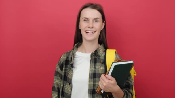 Happy Cute Student Girl Wear Yellow Backpack Holding Two Booksdoing — Αρχείο Βίντεο