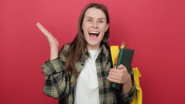 Cheerful Young Pretty Student Woman Holding Books Feeling Happy Surprised — Wideo stockowe