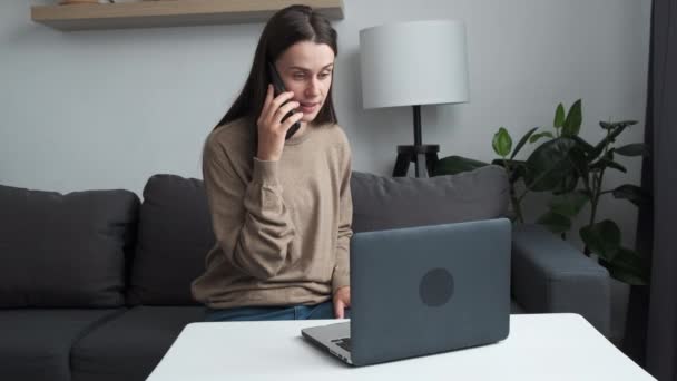 Cute Young Caucasian Woman Professional Talking Phone Using Laptop Sit — Vídeos de Stock