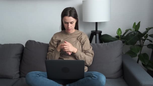 Focused Woman Sit Sofa Living Room Put Portable Computer Laps — Stockvideo