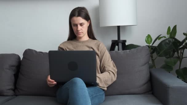 Focused Young Brunette Female Freelancer Sitting Cozy Sofa Working Distantly — 비디오