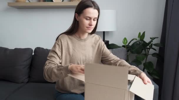 Happy Cute Young Woman Sitting Cozy Sofa Unpacking Box Wished — ストック動画