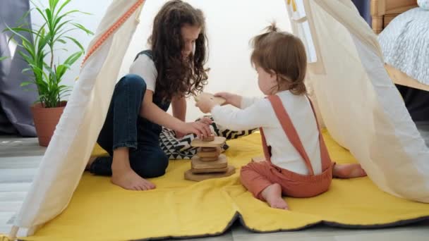 Two Cute Kids Sisters Helping Building Wooden Blocks Together Sitting — Wideo stockowe