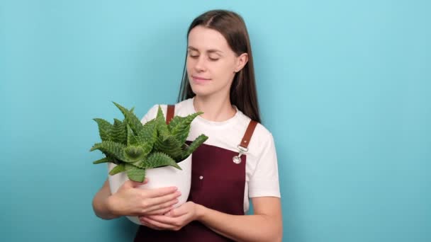 Happy Cute Young Gardener Woman Holding Green Plant Showing Gesture — Stockvideo