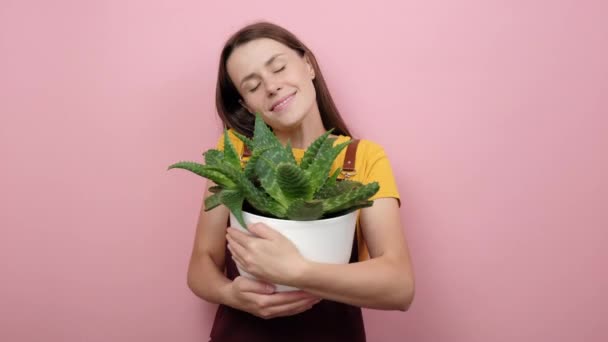 Dreamful Positive Young Girl Closes Eyes Embraces Pot Houseplant New — Stock Video