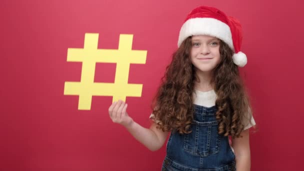 Portrait Little Girl Wearing Santa Hat Holding Hashtag Symbol Promoting — Stock Video